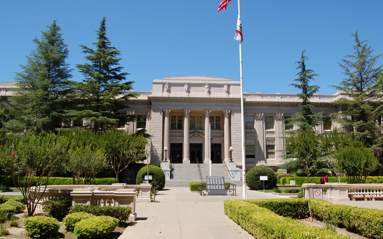 The Romanesque Revival Yolo County Courthouse in Woodland, California, with its brick facade and columns against a clear sky